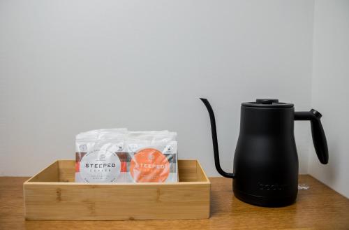 a wooden crate with a coffee maker and a tea kettle at The Vic by Kasa in Traverse City