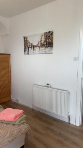 a bedroom with a painting on the wall and a bed at Brits-Halley Luxury Apartments in Annfield Plain