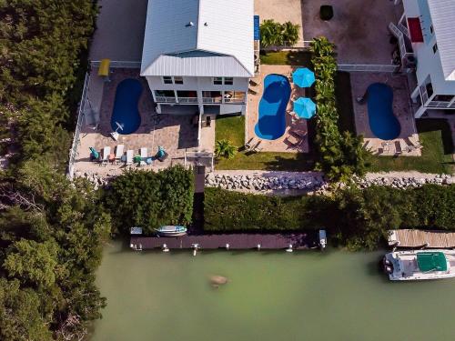 an aerial view of a house with a dock in the water at Sombrero Chic - Waterfront Pool Home Near Sombrero Beach, 40' Dock in Marathon