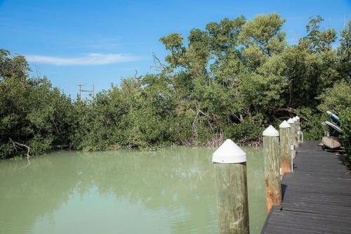 a bridge over a body of water with trees at Sombrero Chic - Waterfront Pool Home Near Sombrero Beach, 40' Dock in Marathon
