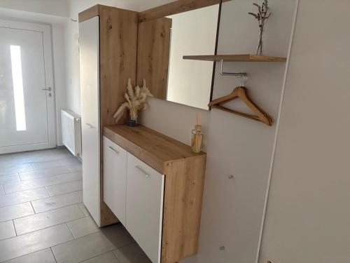 a kitchen with white cabinets and a wooden counter at Deluxe Apartments 55 in Kranjska Gora
