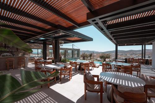 a restaurant with tables and chairs on a patio at Noir Mykonos in Mýkonos City