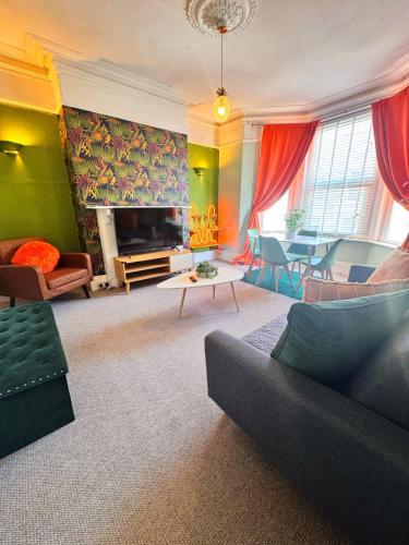 a living room with a couch and a fireplace at Best Offer Spacious and Chic 2 Bed Apartment in Plymouth