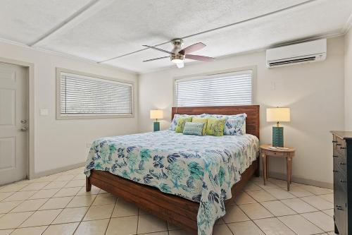 a bedroom with a bed and a ceiling fan at Waterfront Hideaway - Pet Friendly Waterfront Home, 24' Dock in Marathon