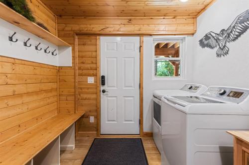 a kitchen with a washer and dryer in a tiny house at Mallard Manor Hot Tub in Duck Creek Village