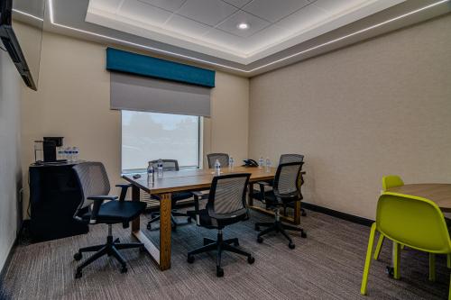 a conference room with a table and chairs at Home2 Suites By Hilton Bolingbrook Chicago in Bolingbrook