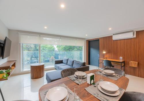 a living room with a table and a couch at Cicerón 612 Aparthotel Polanco in Mexico City