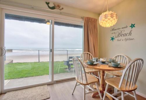 a dining room with a table and a view of the ocean at Oceanfront Suite - Ground Floor in Lincoln City