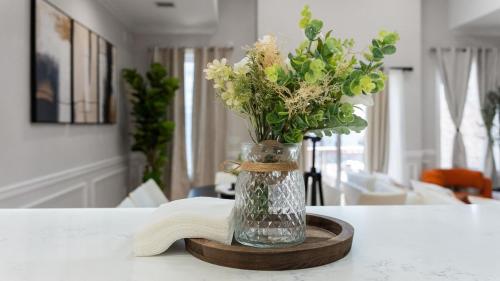 a vase of flowers sitting on a table at Luxury Retreat Walk 2 PATH NYC in Mins Parking in Jersey City