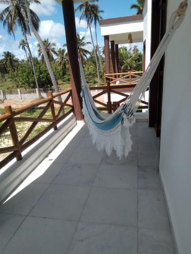 a hammock on the porch of a house at Villas de Guajirú, Casa 2 in Flecheiras