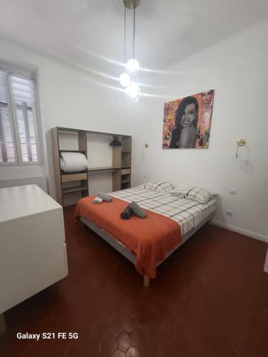 - une chambre avec un lit et une couverture orange dans l'établissement Grand T2 Cours Napoleon B, à Ajaccio