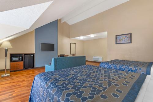 a hotel room with two beds and a flat screen tv at Econo Lodge Inn & Suites Gatlinburg at the Convention Center in Gatlinburg