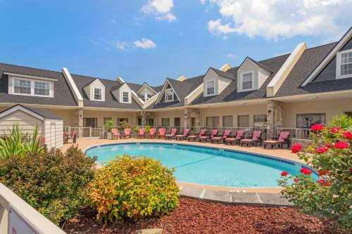 a villa with a swimming pool and patio furniture at Econo Lodge Inn & Suites Gatlinburg at the Convention Center in Gatlinburg