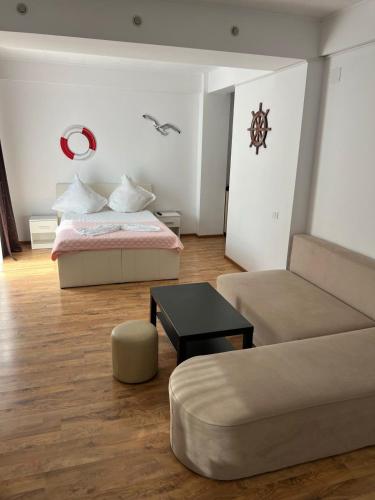 a living room with a bed and a couch at Studio 1 & Studio 2 Aqua in Eforie Nord