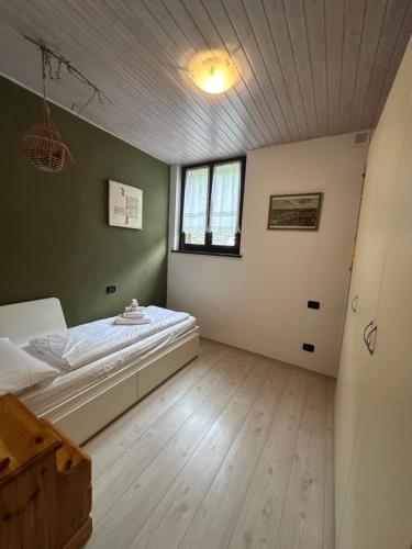 a bedroom with a bed in the corner of a room at Ledro Rustik in Ledro