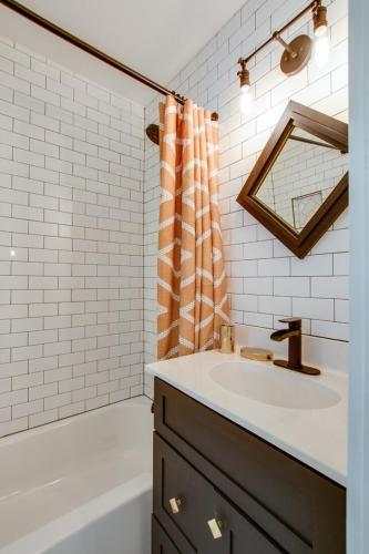 a bathroom with a sink and a shower curtain at The Nashville Diamond in Nashville