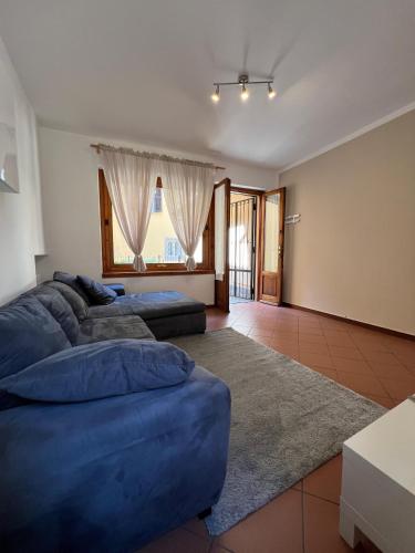 a large living room with two blue couches and a rug at Campidoglio vacation home in Lenno