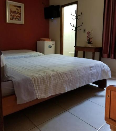 Rúm í herbergi á Hotel Postillon
