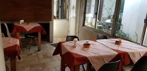two tables in a restaurant with red table cloth at La Casa de Teresa in Colonia del Sacramento