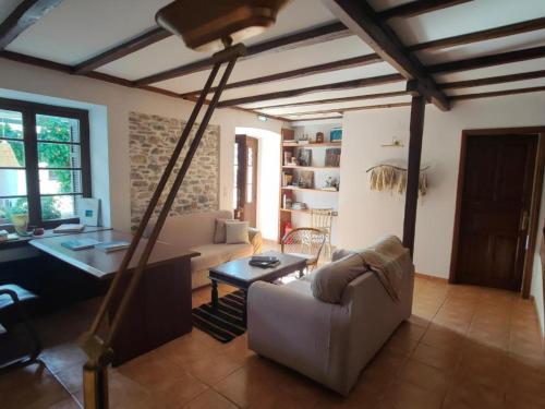 a living room with a couch and a desk at Galini Hotel Agios Ioannis Pelion in Agios Ioannis Pelio