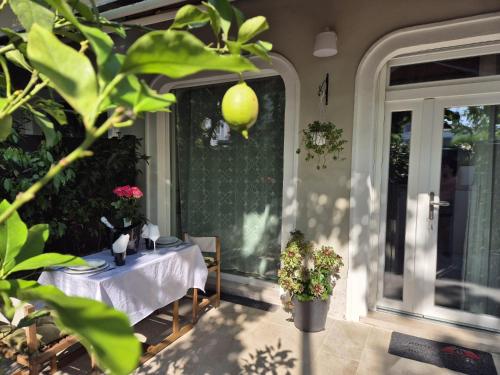 a table on a porch with a table and a window at Villa Joy Verona - Junior Suite in Verona