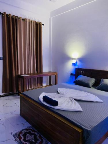 a bedroom with two beds and a bedvisor with at Elite Bay Arugambay in Arugam Bay