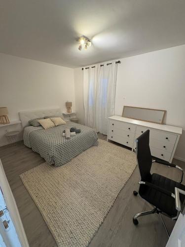 une chambre avec un lit, un bureau et une chaise dans l'établissement Belle maison avec piscine privative dans une résidence calme et securisee, à Sainte-Maxime