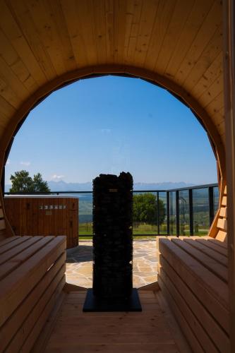 an archway in a wooden building with a view of the ocean at Gorczański Lux Chalet in Szlembark