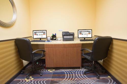 a waiting room with two desks with two computers at Holiday Inn Express & Suites Denver North - Thornton by IHG in Thornton