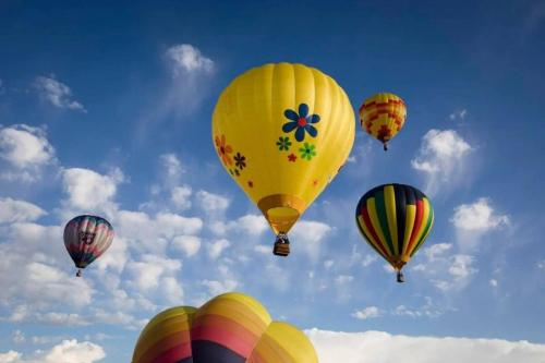 a group of hot air balloons in the sky at Newly Built - South Teton at The Basin Luxury Suit in Driggs
