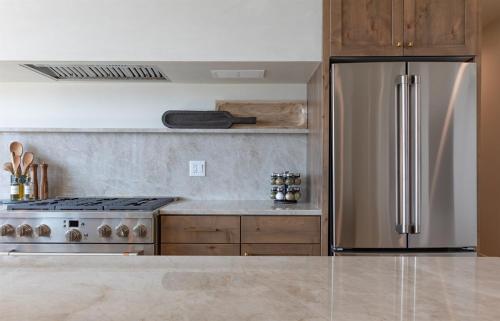 a kitchen with a stainless steel refrigerator and a stove at Newly Built - South Teton at The Basin Luxury Suit in Driggs
