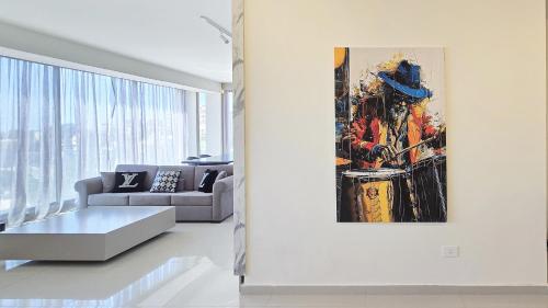 a living room with a couch and a painting on the wall at Tabarja Hills apartment in ‘Ayn aş Şughayrah