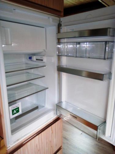 an empty refrigerator with its door open with the door open at Ferienwohnung Schlingshöhe - Oberwohnung mit separater Terrasse in Friesoythe