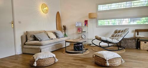 un salon avec un canapé et une table dans l'établissement La Petite Maison dans la Pinède, à Lacanau