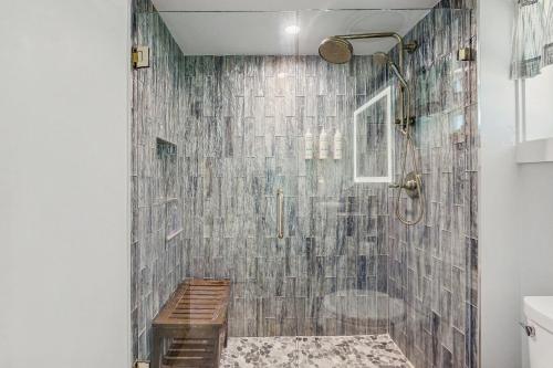 a bathroom with a shower with a tiled wall at Coconut Palms Beach Resort II 4512 in New Smyrna Beach