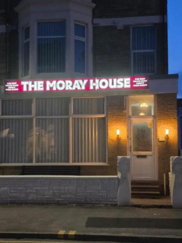 a moryory house with a neon sign in front of it at The Moray House in Blackpool