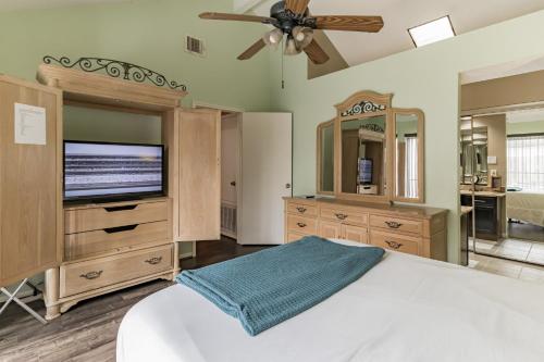 Un dormitorio con una cama y un televisor de pantalla plana. en SW Houston Eclectic Living, en Houston