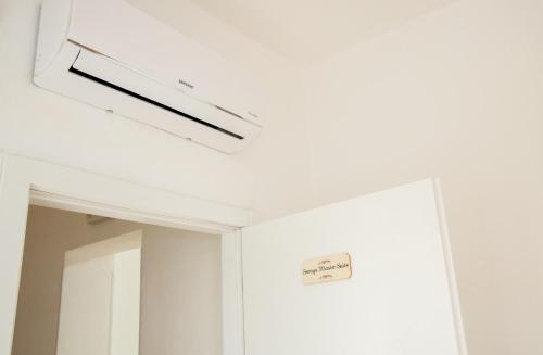 a room with a mirror and a sign on the ceiling at Soraya - Suites & Apartments in Palau