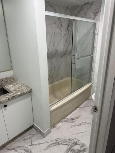 a bathroom with a shower with a glass door at au pied du nord in Saint-Jérôme