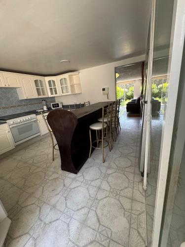 a kitchen with a bar and chairs in a room at Casa Xochimilco in Mexico City