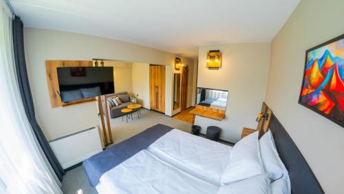 a bedroom with a bed and a living room at Villa Veranda in Smolyan