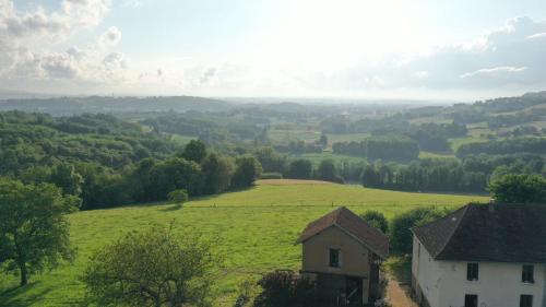 a view of a green field and a house at La Nyvolette in Avressieux