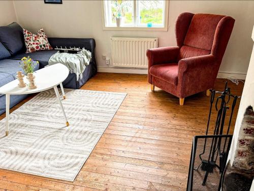 a living room with a couch and a chair at 5 person holiday home in Åryd in Åryd