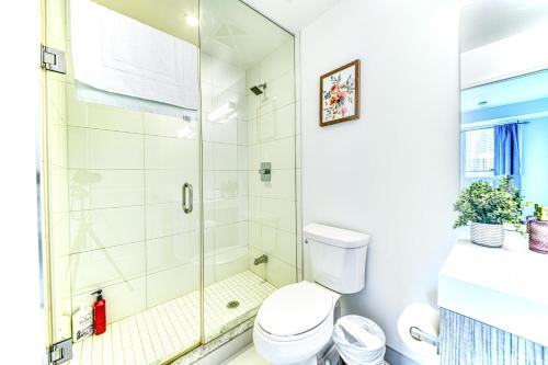 a bathroom with a shower and a toilet at RivetStays - The Jarvis in Toronto