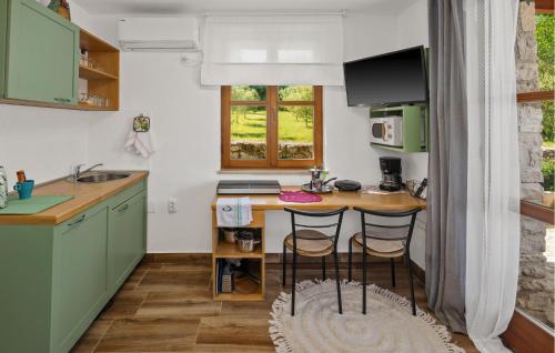 a kitchen with a counter and two bar stools at Olive in Rovinj
