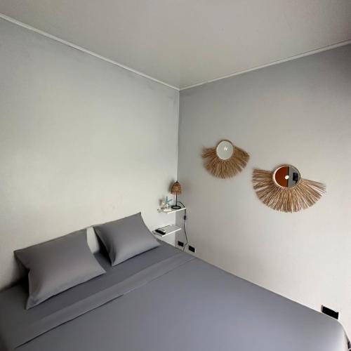 a bedroom with a bed and two mirrors on the wall at Punta Leona Beach Condos in Jacó