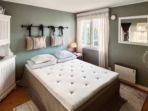 a bedroom with a large bed in a room at 4 star holiday home in VARBERG-By Traum in Varberg