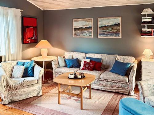a living room with two couches and a table at 4 star holiday home in VARBERG-By Traum in Varberg