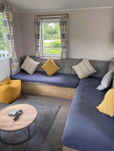 a living room with a couch and a table at On the Lake Weeley in Weeley