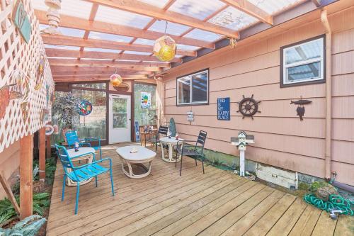 a patio with chairs and tables on a wooden deck at Garden Shores in Long Beach